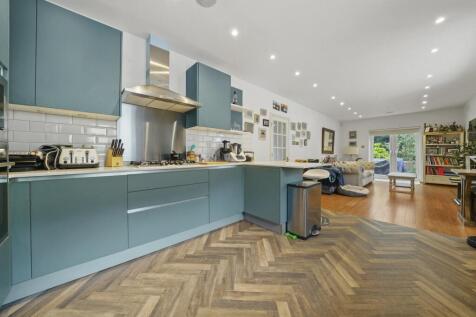 Stylish open-plan kitchen with modern cabinetry...