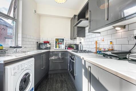 Modern gloss kitchen with sleek integrated unit...