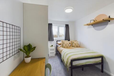 A bright and inviting double bedroom with moder...