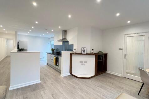 Open-plan living area with modern kitchen...