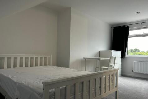 A bright and spacious double bedroom featuring ...