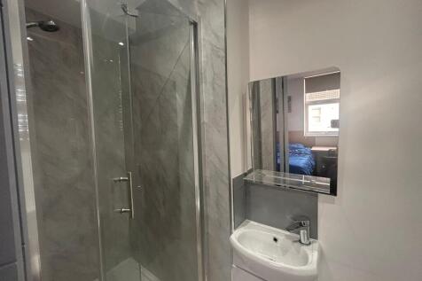Modern ensuite with glass shower and vanity...