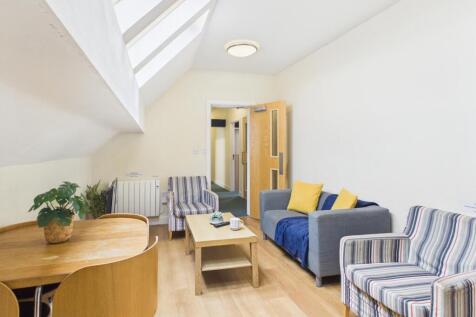 Bright, modern living space with skylights, lig...
