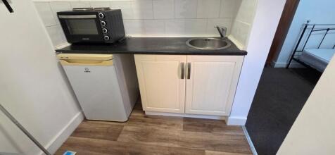 Compact kitchenette with sink and fridge...