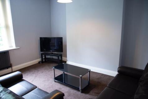 A modern and tidy living room featuring comfort...