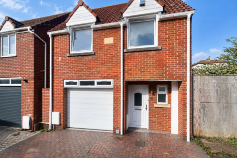 Sunlit Red-Brick House and Driveway.png
