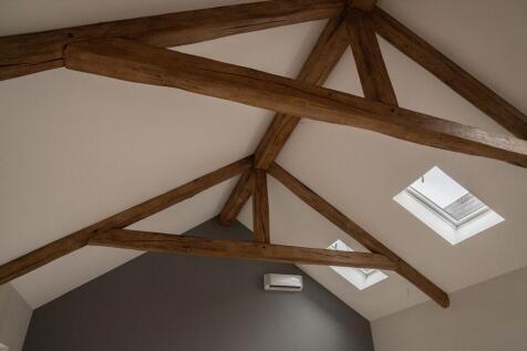 Open plan kitchen/dining living space under vaulted ceilings