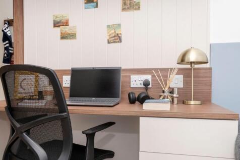 Well-arranged bedroom study area with a wooden ...
