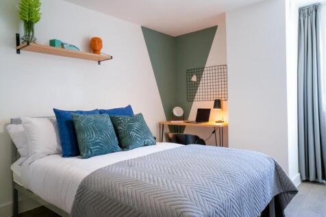 A bright and welcoming double bedroom featuring...