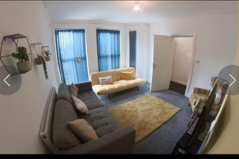 Bright, modern living room with two comfortable...