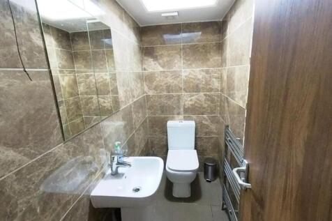 Modern tiled bathroom with sleek white fixtures...