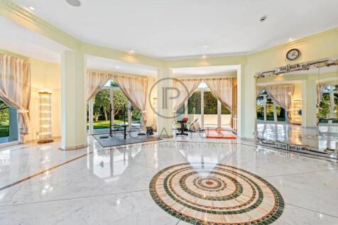 Spacious indoor gym with large windows, a mirrored