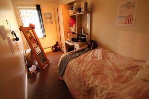 Cozy single bedroom with a comfortable bed, she...