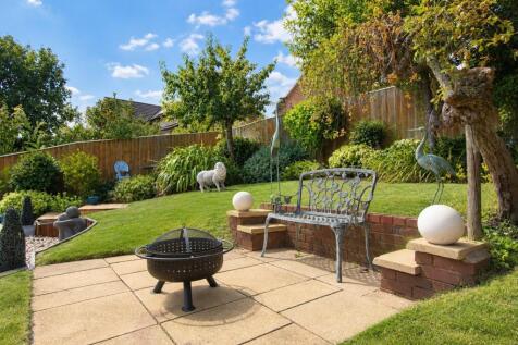 Sunny Garden Patio with Sculptures and Fire Pit.jp
