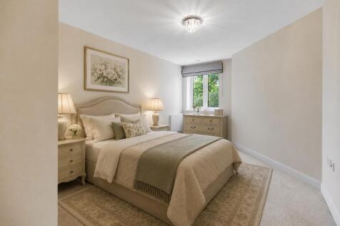 a bedroom with a bed and lamps