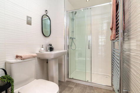 En suite shower room in three bedroom home