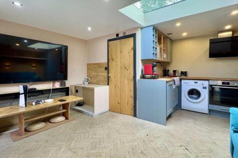 Bright lounge with skylight and huge smart TV...