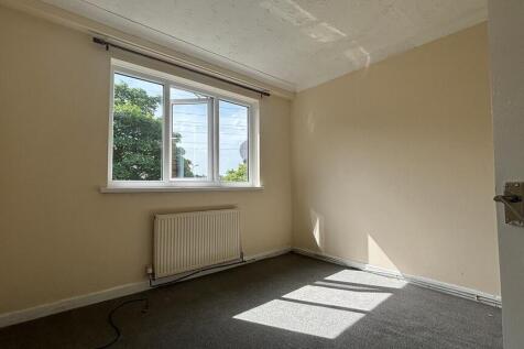 Bright and airy bedroom with large window...