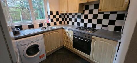 Neat fitted kitchen with L-shaped worktops, bui...
