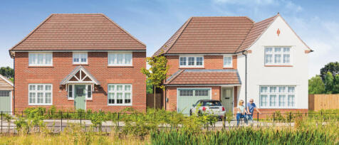 Two modern detached houses with red brick and white facades, front gardens, and a couple walking alo