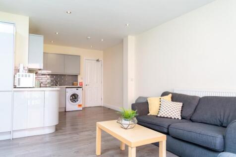 A bright and inviting living room featuring a c...