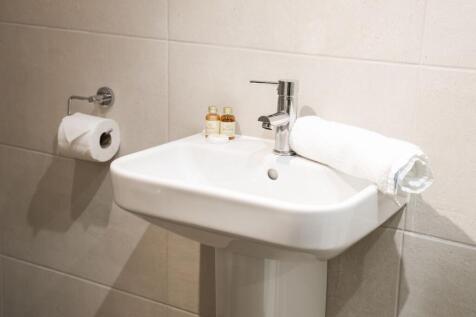 Bright modern bathroom sink with fresh towels...