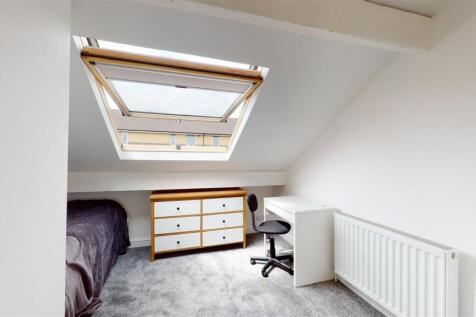 Bright attic room with large skylight and desk...
