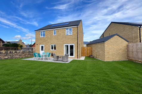 Lush Green Lawn and Stone House.png