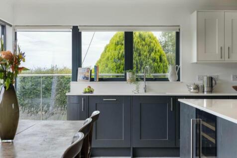 Kitchen sink framed by lush garden views