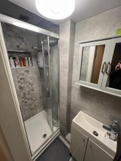 Sleek modern shower with stylish grey tiling...