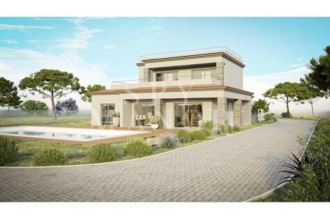 Luxury 2-storey detached villa in Vale del Rei, Carvoeiro, featuring a modern exterior, paved driveway, private swimming pool, and scenic Algarve landscape surrounding the property.
