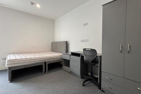 Modern bedroom with study space and storage...