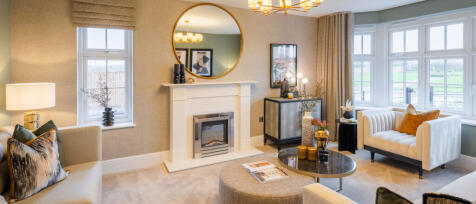 Redrow spacious lounge with fireplace and bay windows with stylish furnishings