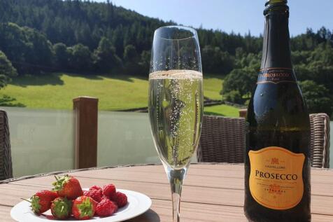 Prosecco And Fresh Berries On The Lodge Decking Ov