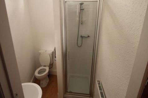 A clean and modern bathroom featuring a shower ...