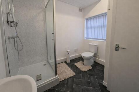 Bright, modern bathroom with a walk-in shower, ...