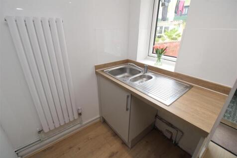 Bright and tidy utility space with sleek sink...