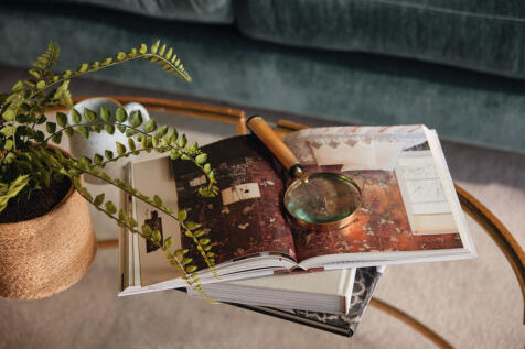Books and magnifying glass on coffee table in living room