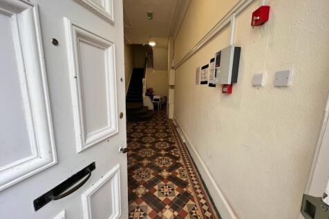 Welcoming entrance hallway with decorative tile...