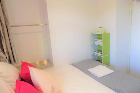 Bright, neatly presented bedroom with a made do...