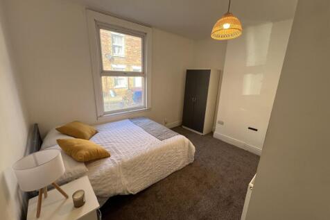 A bright and welcoming double bedroom featuring...