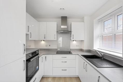a kitchen with white cabinets