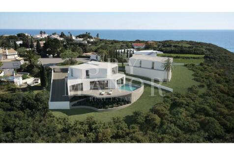 Aerial view rendering of a modern white luxury villa with an infinity pool and ocean views for sale in Vale de Lapa, Carvoeiro, Algarve