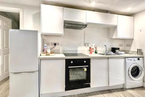 Bright modern kitchen with integrated appliance...