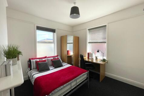 Bright, neatly styled bedroom with a double bed...
