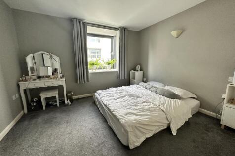 Bright, spacious bedroom with stylish vanity....