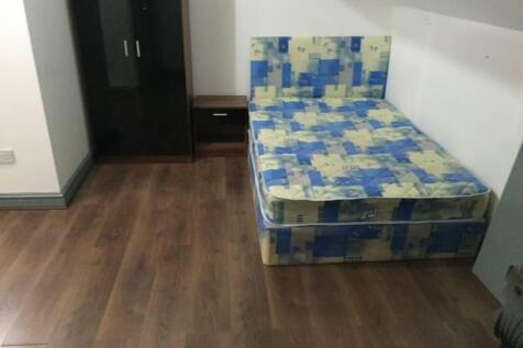 Neat furnished bedroom with a double bed, woode...