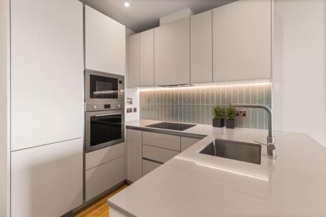 Experience luxury with this impeccably designed modern kitchen featuring state-of-the-art appliances.