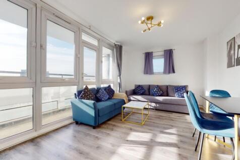 Bright, stylish lounge with floor-to-ceiling gl...