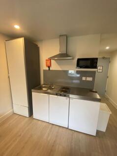 Modern compact kitchenette with stainless steel...